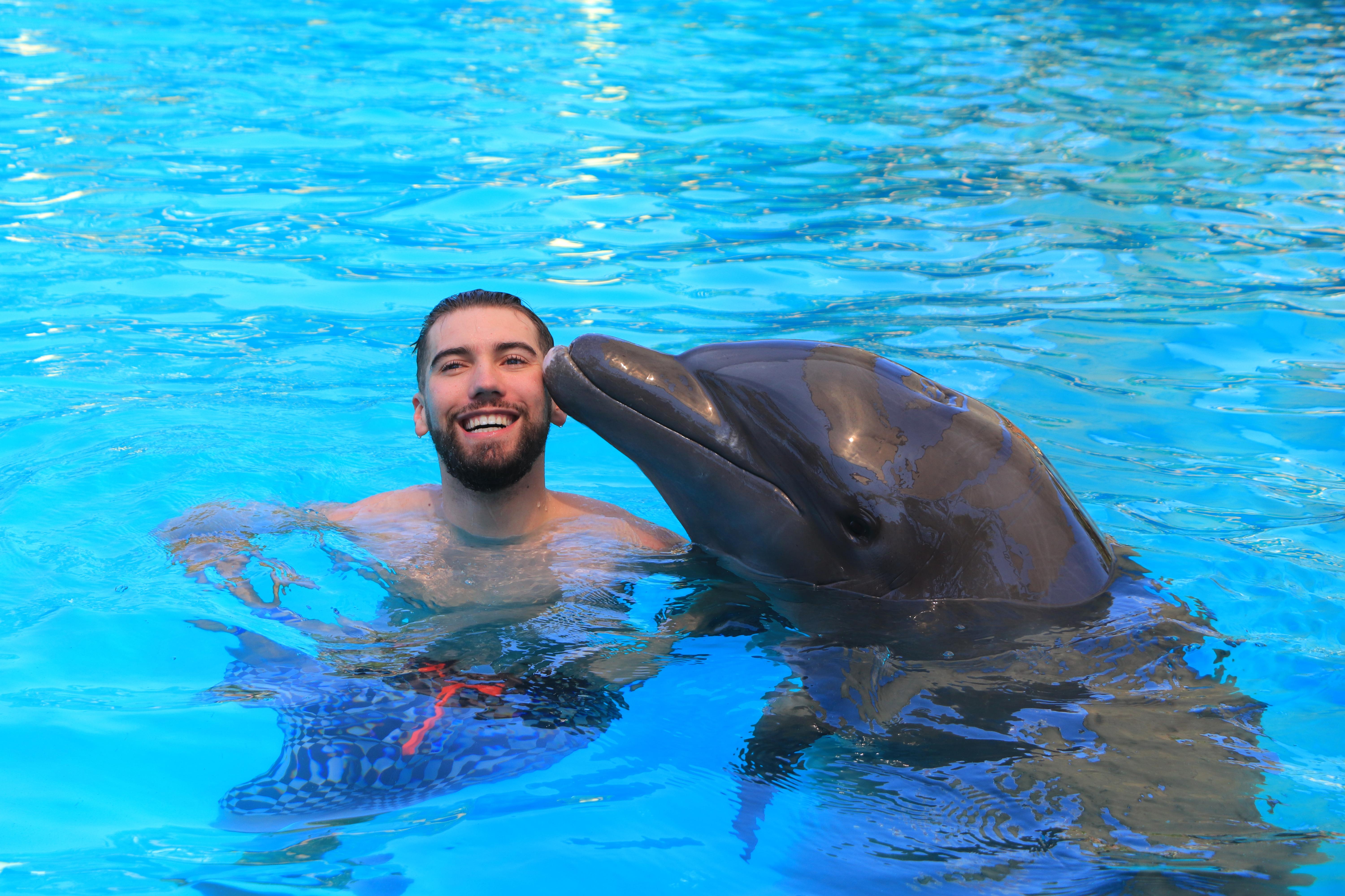 Tanner swimming with a dolphin